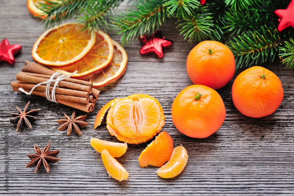 Tangerines and Christmas tree branches on a wooden table. Natura