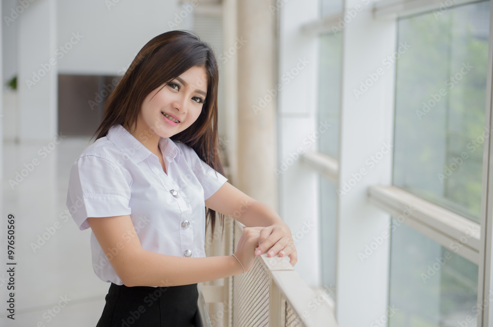 young attractive asian  girl in a uniform of university