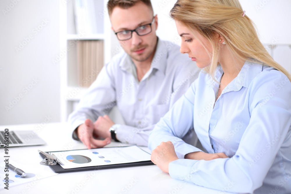 Two successful business partners working at meeting in office Two successful business partners working at meeting in office
