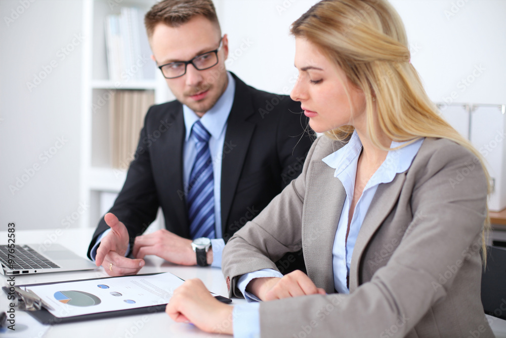 Two successful business partners working at meeting in office Two successful business partners working at meeting in office