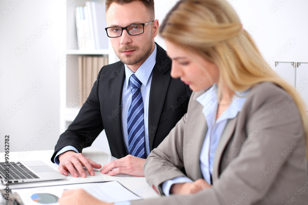 Two successful business partners working at meeting in office Two successful business partners working at meeting in office