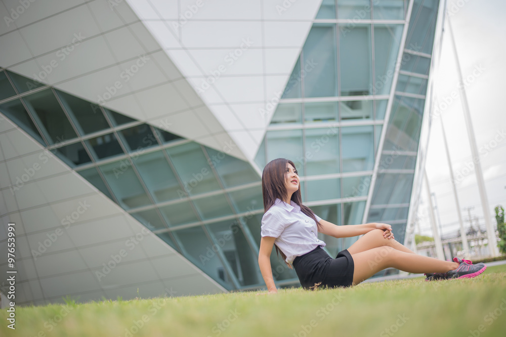 young attractive asian  girl in a uniform of university