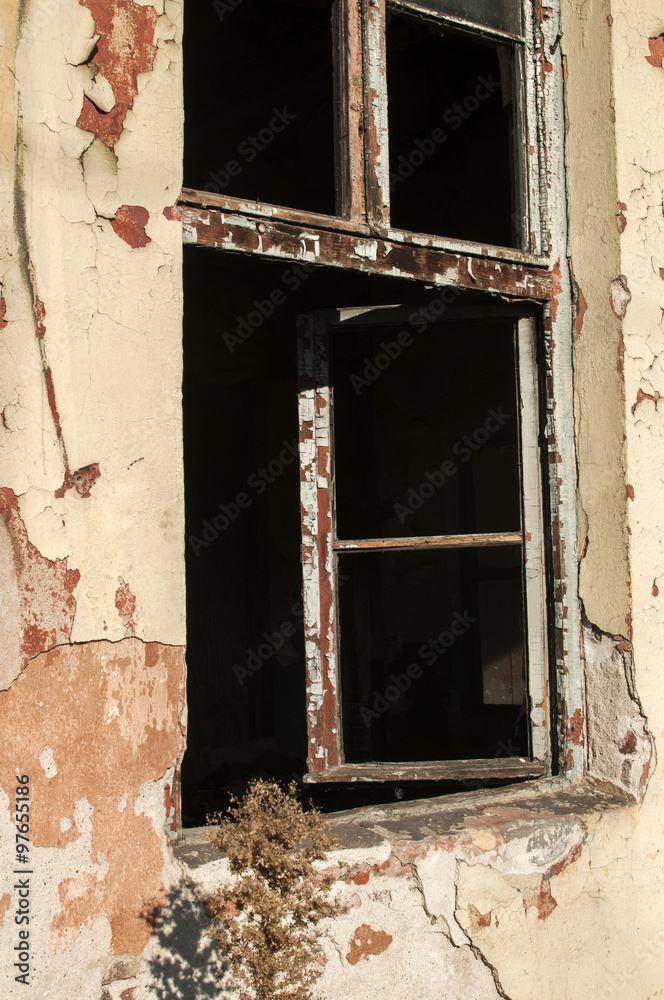 Crumbling wall of abandoned grunge building with broken window Crumbling wall of abandoned grunge building with broken window