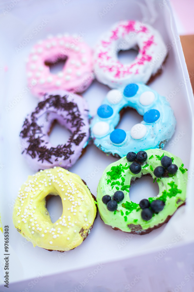 
sweets and colorful donuts in box