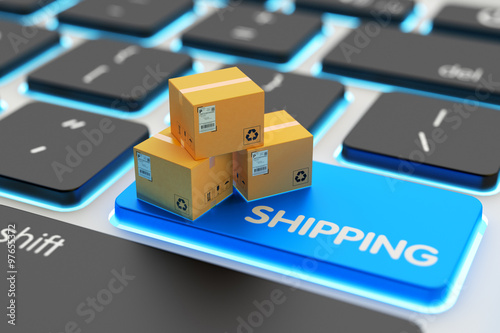 Internet shopping, online purchases, e-commerce, packages delivery and shipping service concept, cardboard boxes on computer keyboard key closeup view