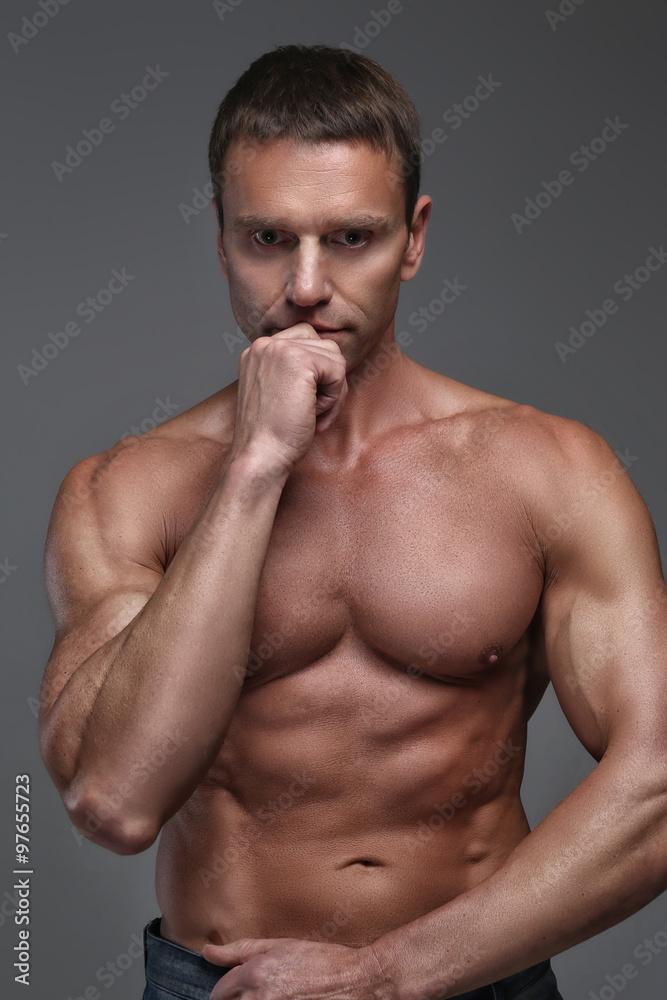 Shirtless man isolated on grey background. Shirtless man isolated on grey background.