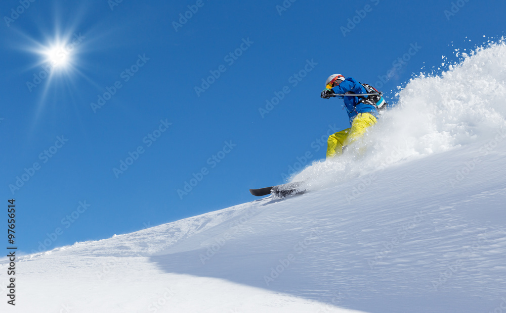 Man skier running downhill