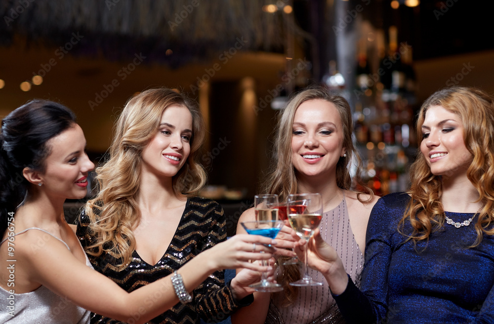 happy women with drinks at night club happy women with drinks at night club
