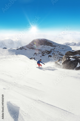 Snowboarder running down on piste