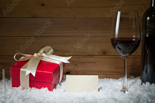 Concept of celebration with gift box, empty card, wine glass on