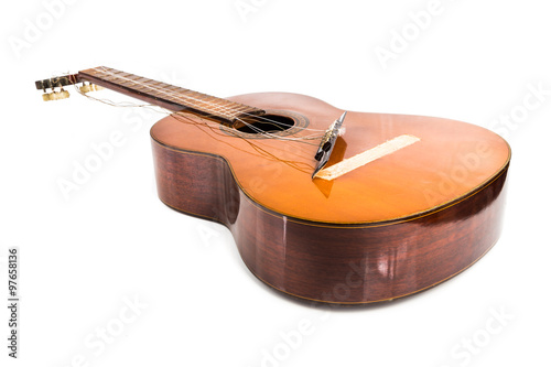 Broken brown classical guitar with detached bridge from body isolated in white background