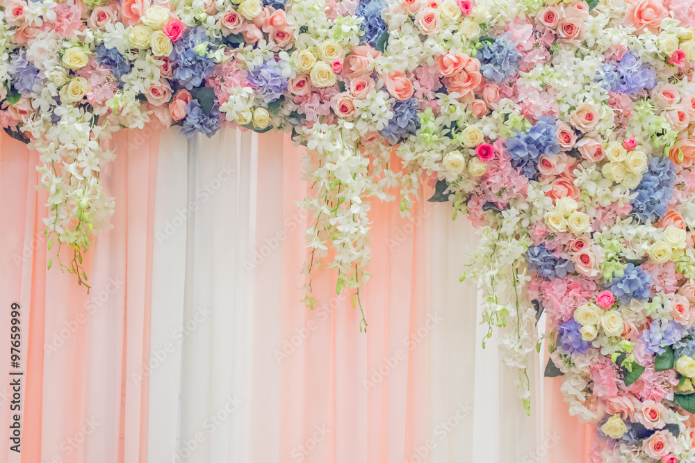 Obraz premium Beautiful flowers over fabric backdrop for wedding ceremony