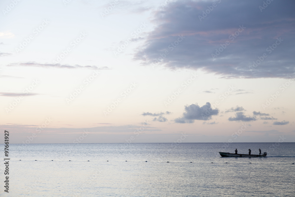 Calm and tranquil evening sea with fishing boat