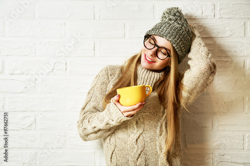 Romantic Dreaming Hipster Girl in Winter Clothes with a Mug