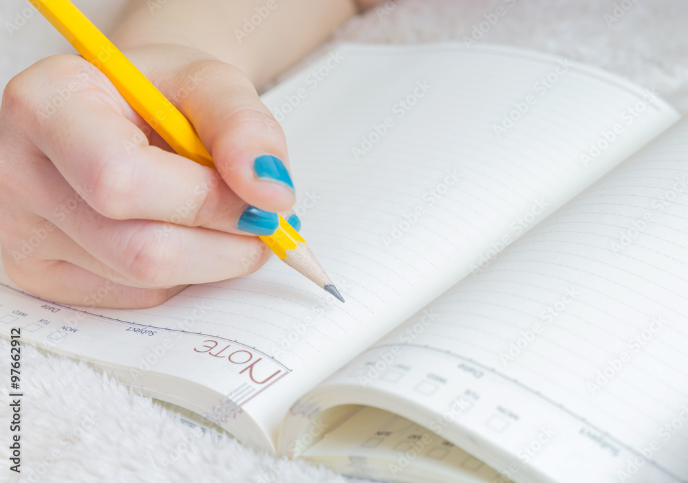Women writing and recording on a notebook
