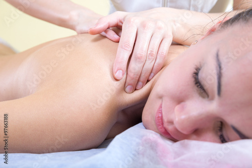 Client smiling during a back massage