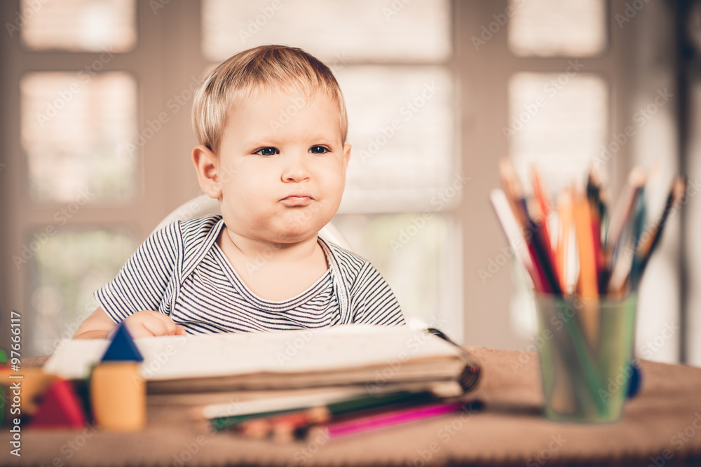 Little boy learns to lines and writes