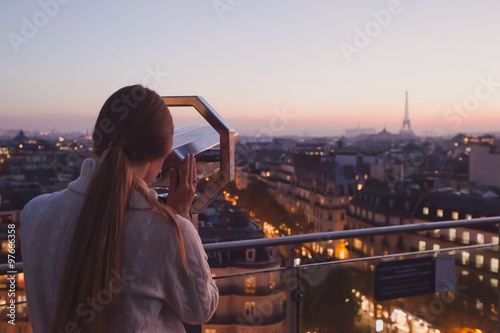 tourist looking to Eiffel tower through binocular © Song_about_summer
