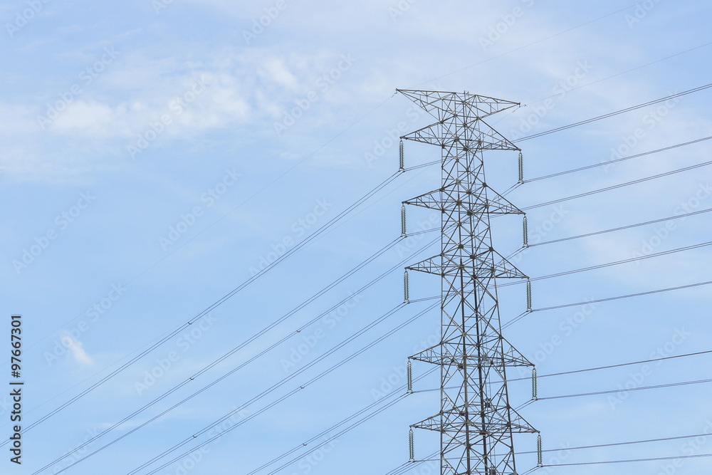 Pylons and cables silhouetted against sky and clouds Pylons and cables silhouetted against sky and clouds