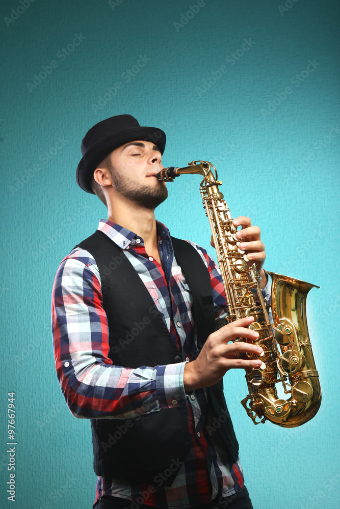 Fototapeta premium Saxophone player on blue background