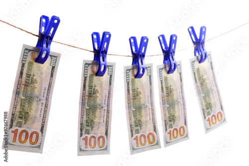 Concept of money laundering - dollars are drying on cord isolated on white background