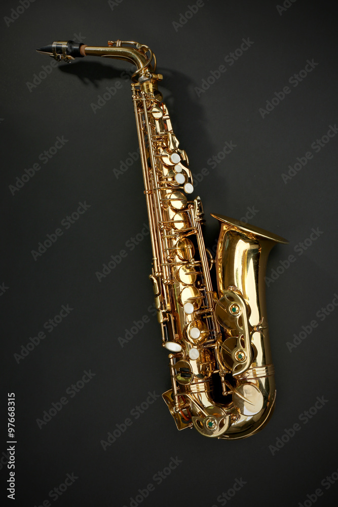 Fototapeta premium Beautiful golden saxophone on black background
