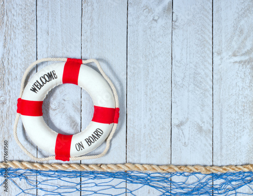 Fototapeta Welcome on Board - Lifebuoy with text on wooden background with copyspace for individual text