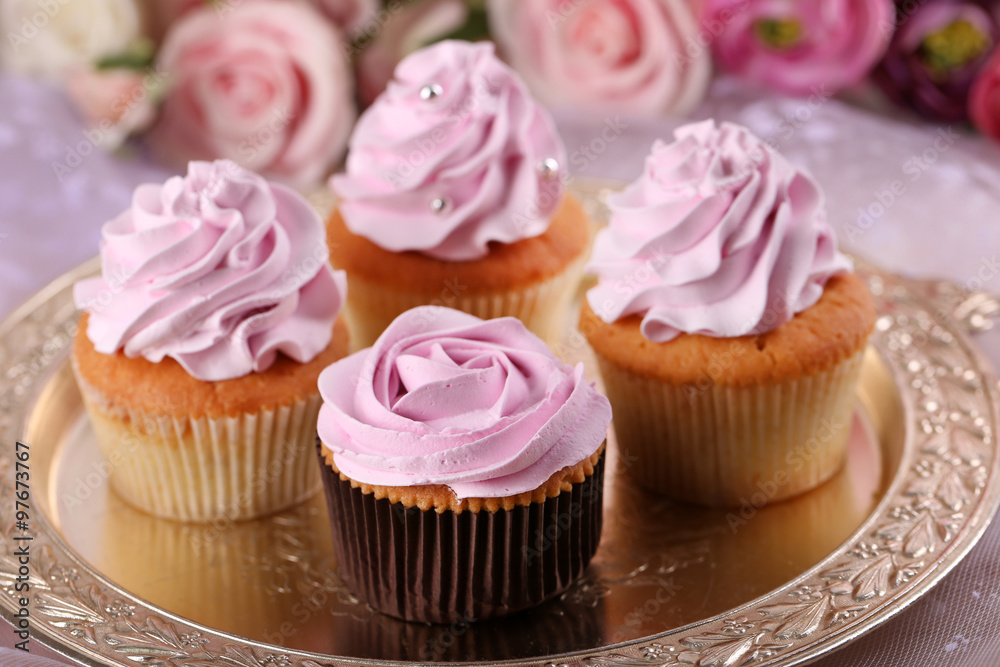 Tasty cupcakes on bright background