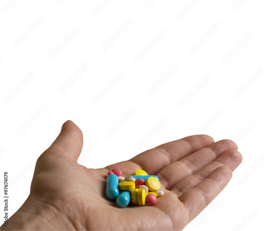 Colored pills, tablets and capsules in hand Colored pills, tablets and capsules in hand