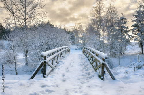 Snowy, wooden bridge in a winter day. Stare Juchy, Poland.