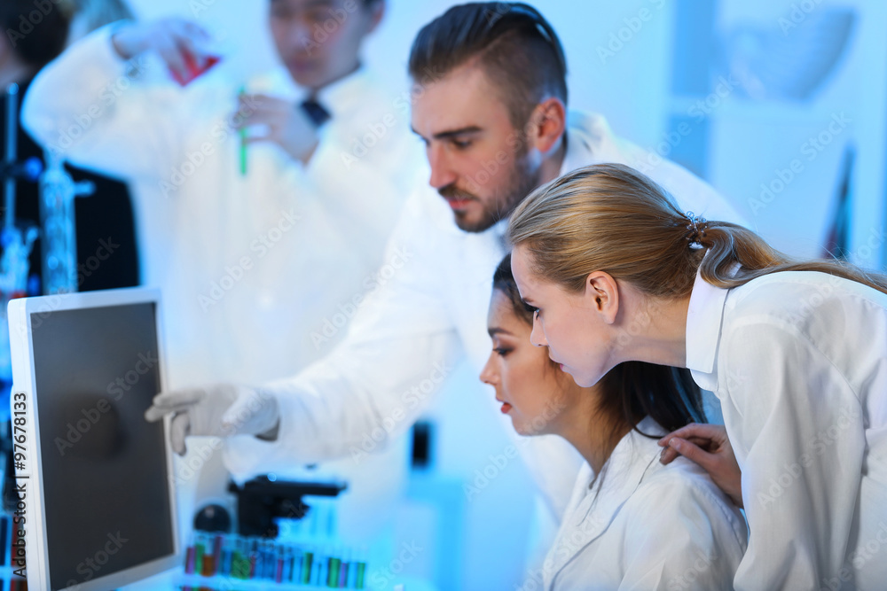 Young medical technicians working in laboratory Young medical technicians working in laboratory