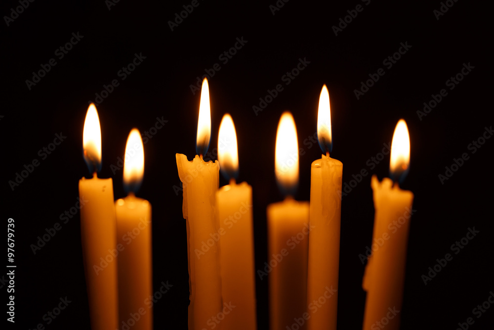 Many burning candles on black Many burning candles on black