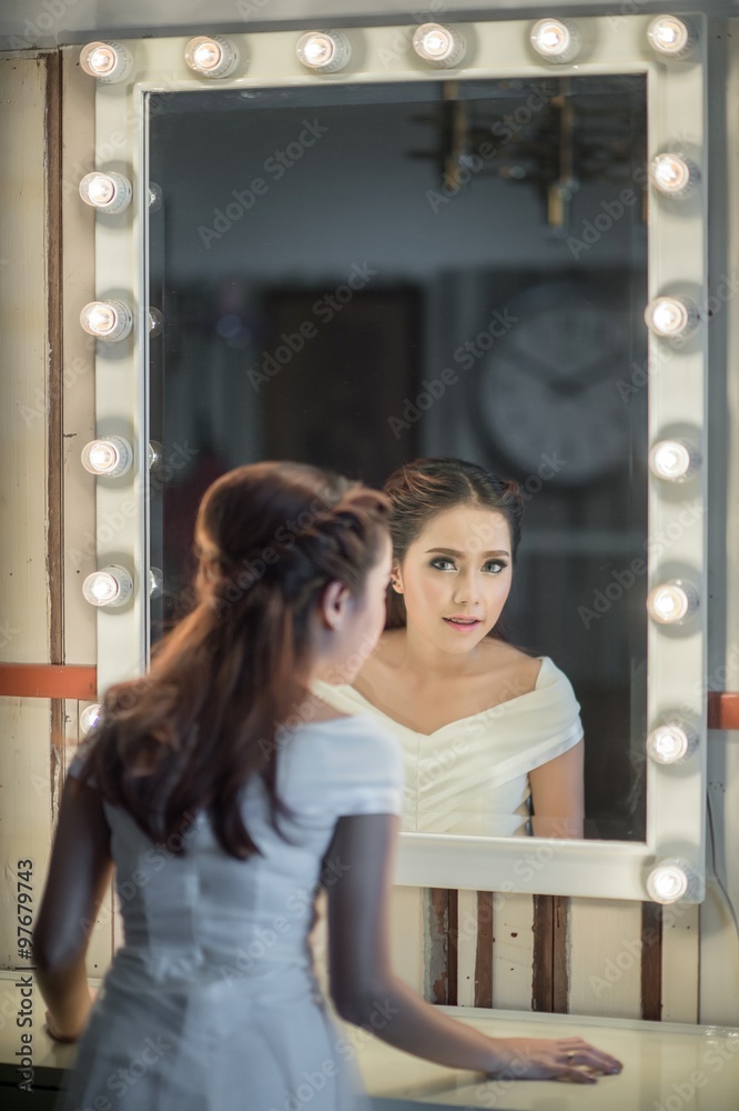 Fototapeta premium Young asia beautiful woman standing front of mirror in room