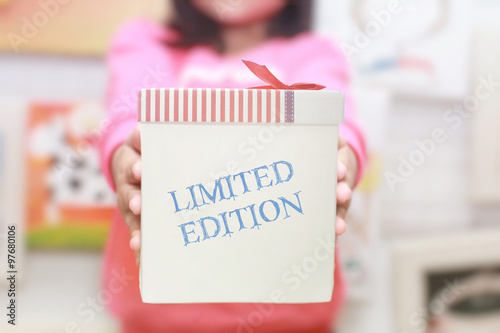 Bilde på lerret Gift box in young girl's hands with wording LIMITED EDITION.So