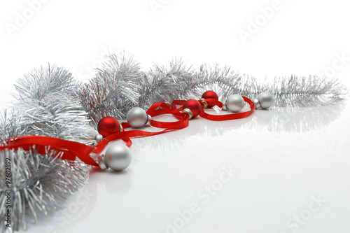 Greeting card template made of red ribbon, silver tinsel and balls with copy space, horizontal view, selective focus