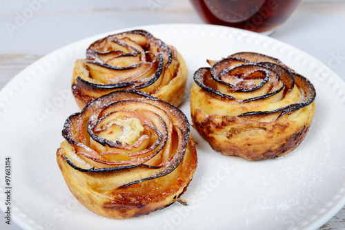 three apple tartlets on white plate