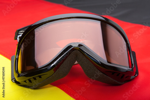 Winter sport goggles over German flag