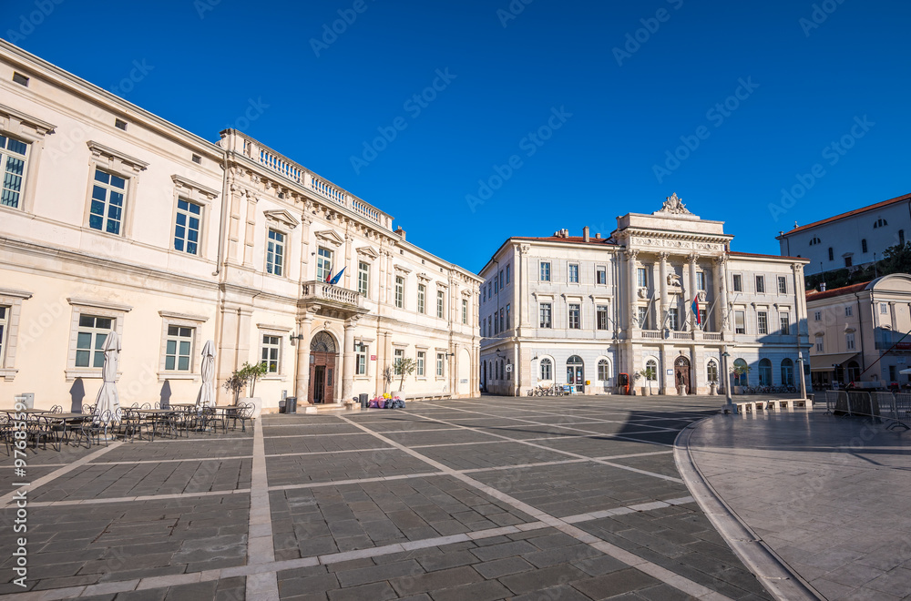 Town Hall and City Library Buildings on Tartini Square in Piran, Slovenia on a Hot Summer Day with Clear Blue Sky
