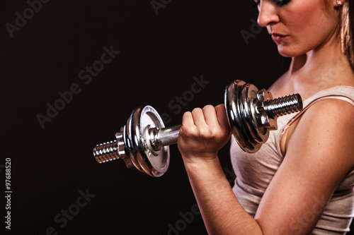 athletic woman working with heavy dumbbells