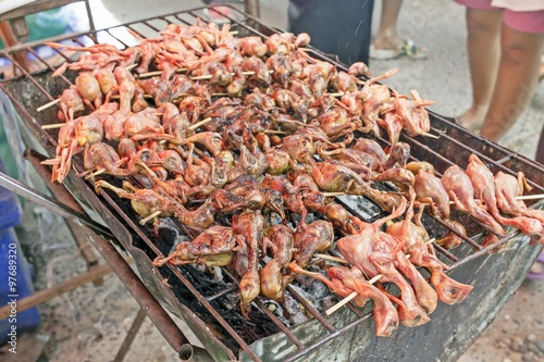 chicken grilled on stove at street food market - thailand countryside Chiken on the grill 