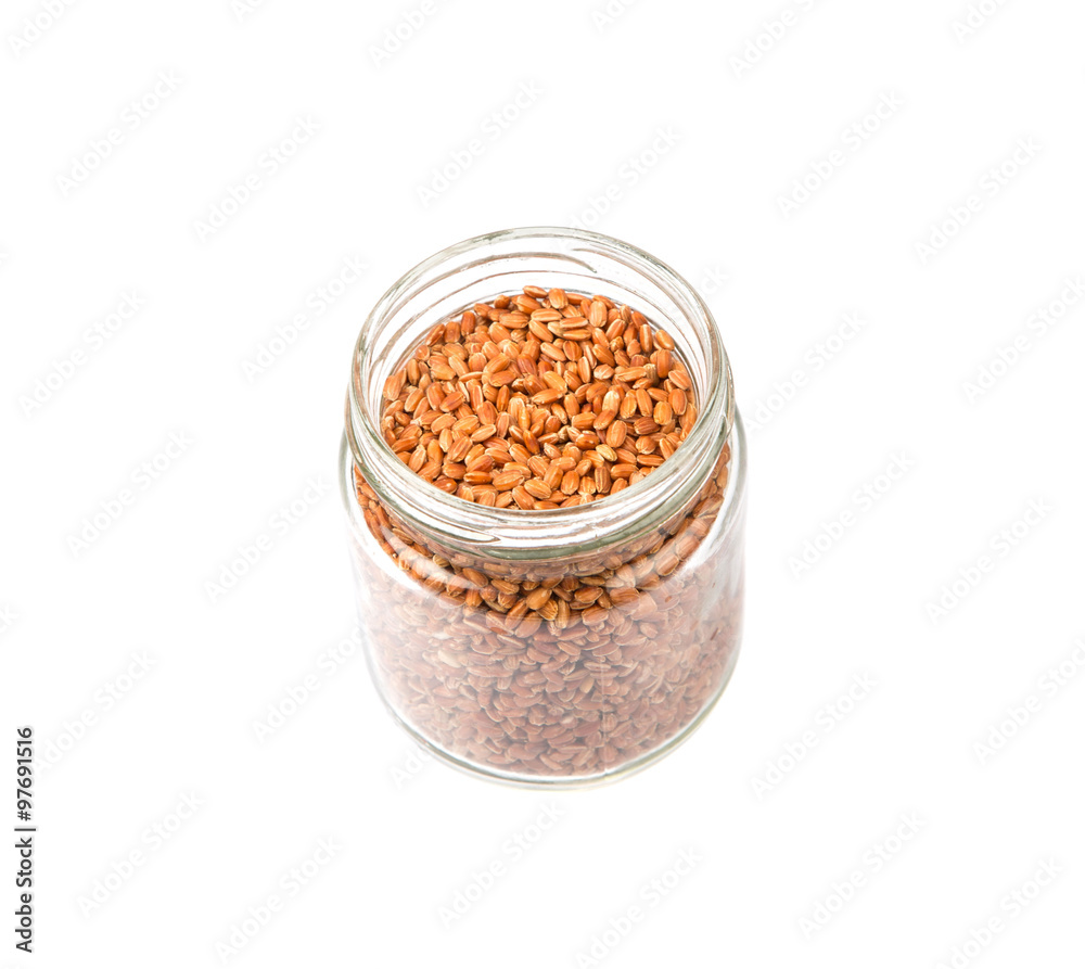 Brown millet grain seed in mason jar over white background Brown millet grain seed in mason jar over white background