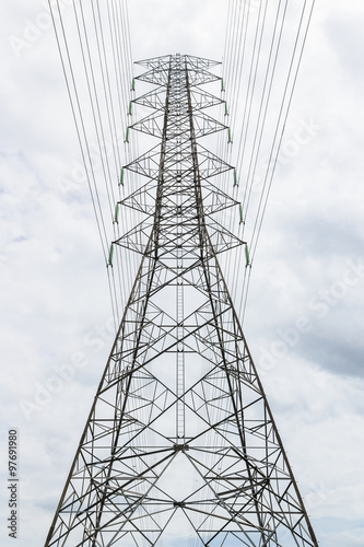 Pylons and cables silhouetted against sky and clouds