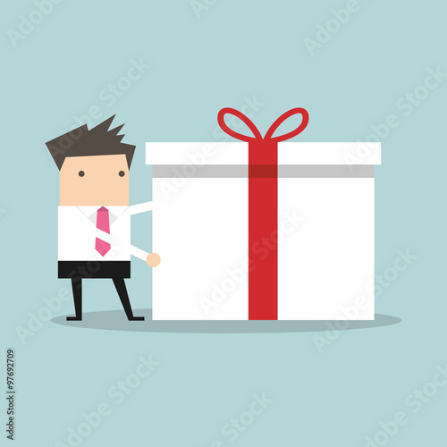 Businessman holding a big gift box for Christmas festival