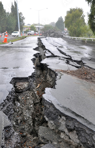 Enormous cracks in a road caused by a devastating earthquake on a rainy day in Christchurch, New Zealand.