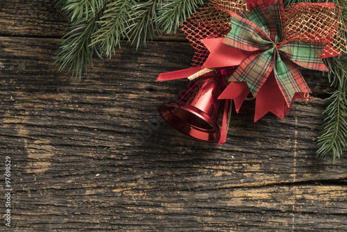 Still life of christmas ornament and tree branch on wooden board