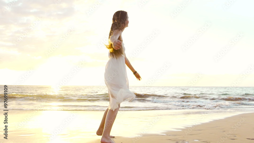 Happy Girl Having Fun at the Beach on Luxury Island at Sunset. Model Girl Spinning in SLOW MOTION Splashing Feet Wet. Happy Girl Having Fun at the Beach on Luxury Island at Sunset. Model Girl Spinning in SLOW MOTION Splashing Feet Wet.