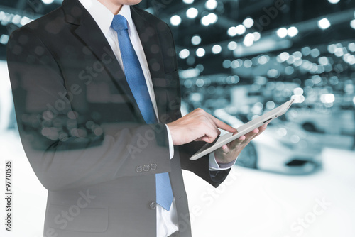 Double exposure of Businessman using digital tablet to handle sa photo