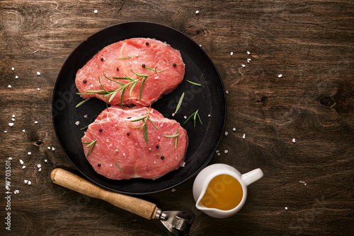 Pork cutlet. Two pieces of raw meat ready for preparation with g photo