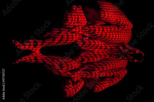 The body of woman with red pattern and its reflection