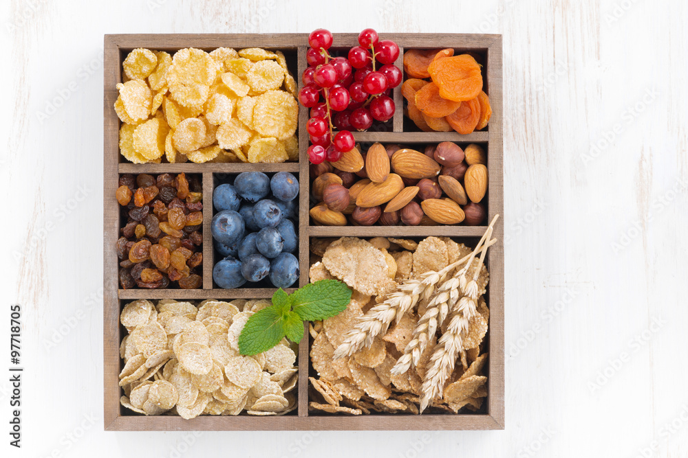 assortment of breakfast cereal, dried fruit, berries and nuts 